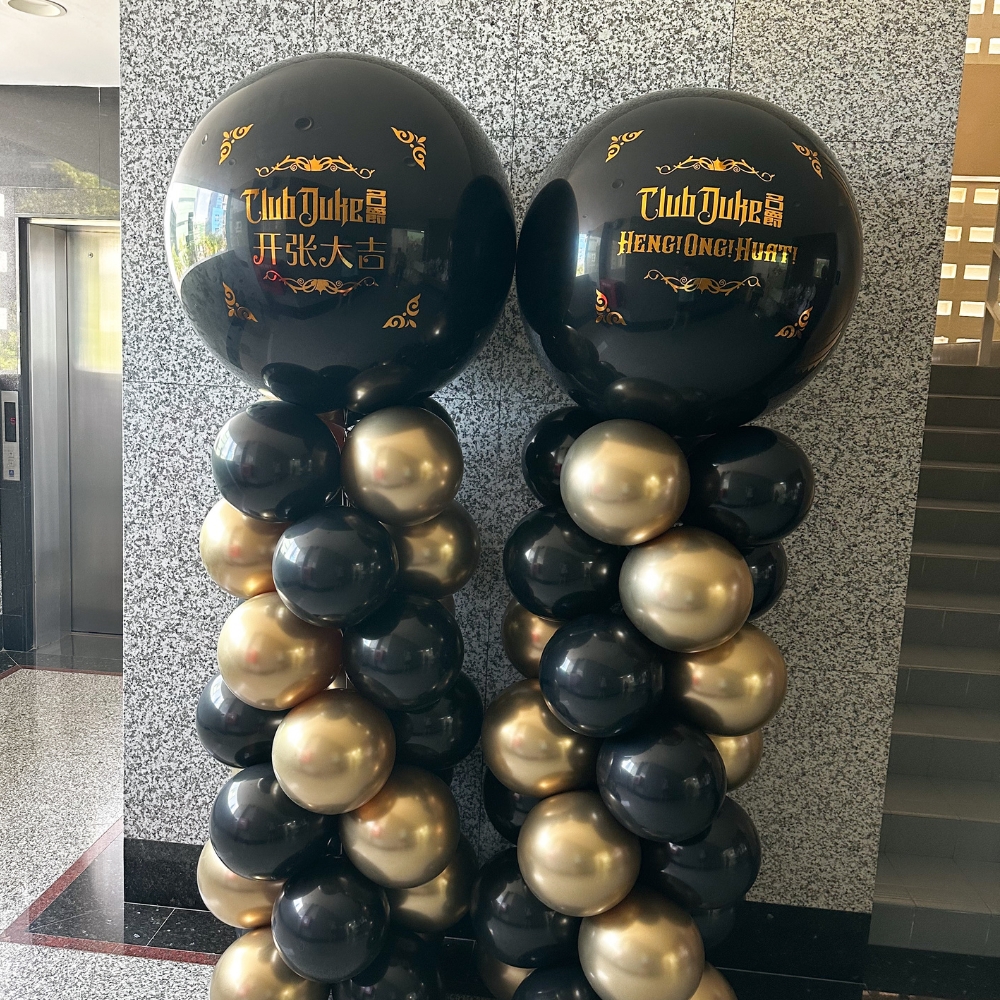 Grand opening balloon columns in black and gold