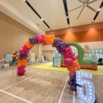 Organic balloon arch in orange, purple, pink