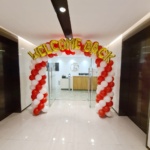 Welcome back balloon arch for office re-opening in red and white